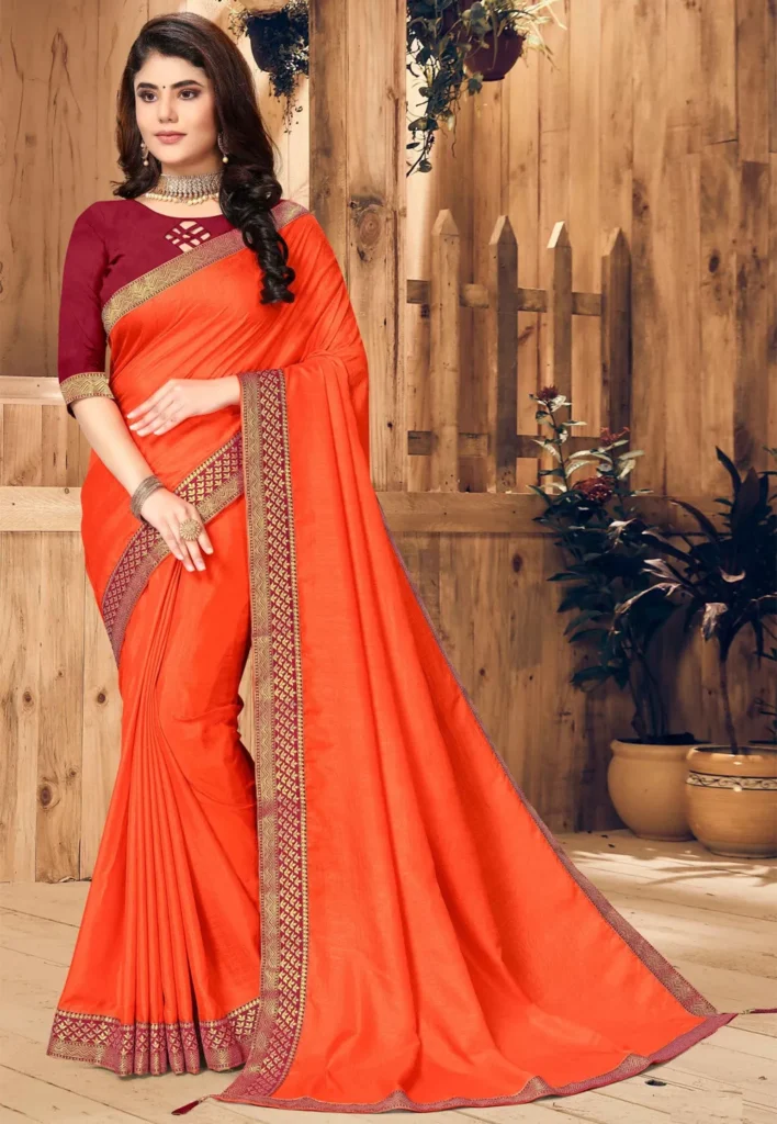 Orange Tusar Silk Saree with Contrast Pink Border** A vibrant orange Tusar silk saree featuring a contrasting pink border, blending rich color and traditional elegance, perfect for festive occasions and celebrations.