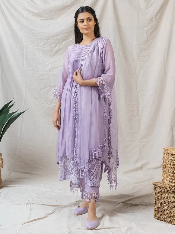 This elegant lavender Chanderi silk salwar suit features a soft, flowing fabric with delicate embroidery, paired with a lightweight organza dupatta. 