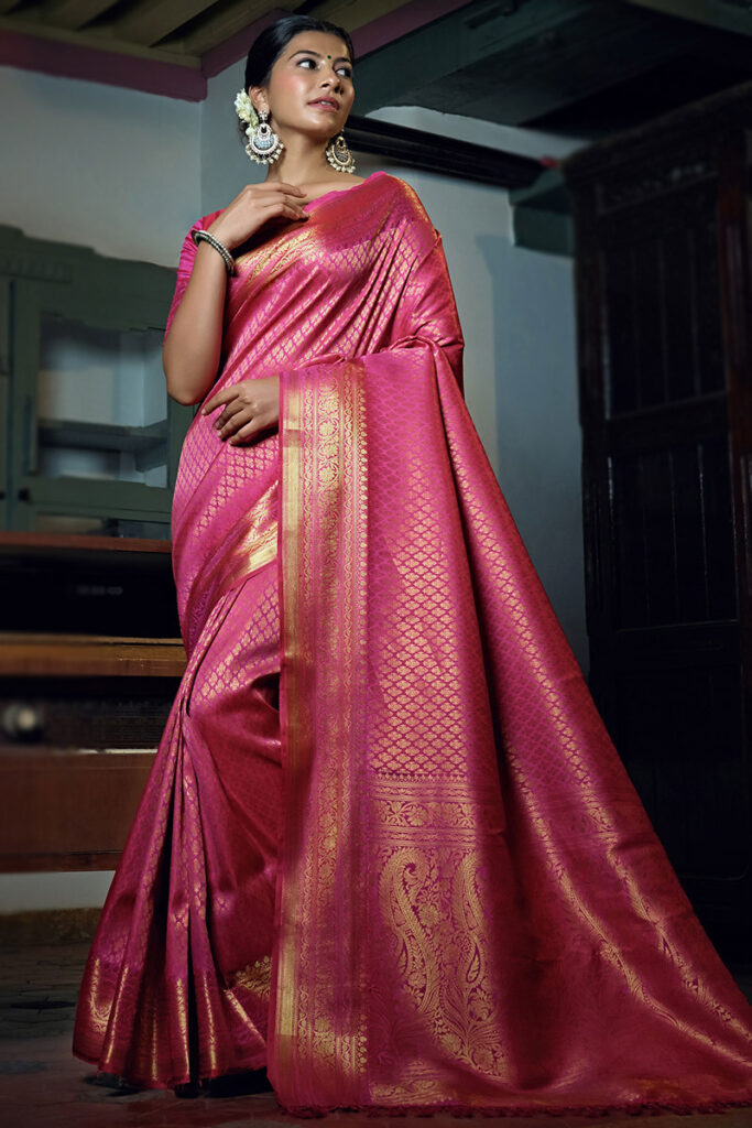 A light pink and magenta digital printed Kanchipuram silk saree with intricate floral patterns, featuring a rich Zari border for a modern yet traditional look.